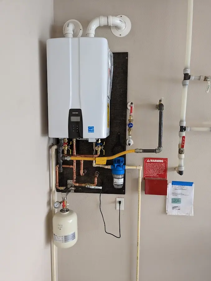 Professional plumber installing copper piping in a Otis Orchards-East Farms home